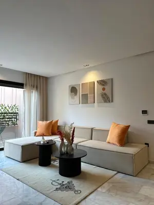 a living room with a couch and a table at Appart haut standing - centre ville in Marrakech
