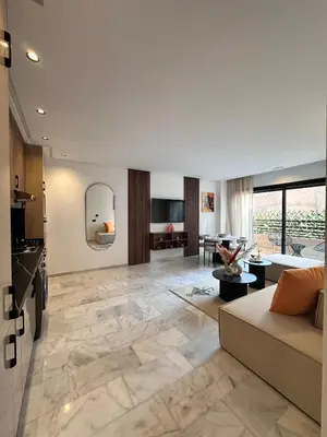 a living room with a couch and a table at Appart haut standing - centre ville in Marrakech