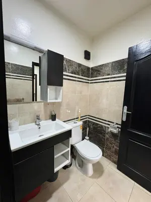 a bathroom with a white toilet and a sink at Beautiful Luxurious 2-bedroom with Wi-Fi Gueliz, Marrakech in Marrakech