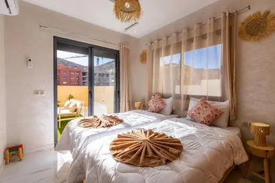 a bedroom with a large bed with a large window at Luxe et Calme de Guéliz avec Grande Terrasse in Marrakech