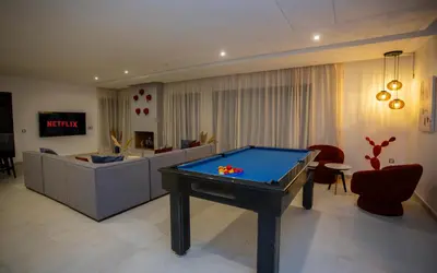a living room with a pool table in it at Atlas Twin in Marrakech
