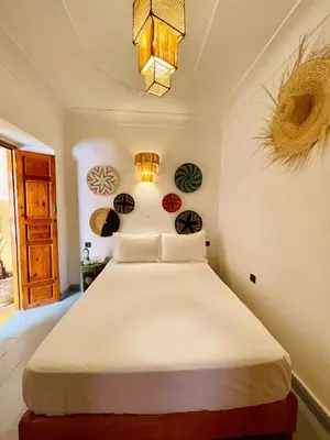 a bedroom with a large white bed in a room at Riad Numidia in Marrakech