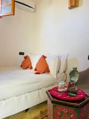 a living room with a white couch and a table at Riad Numidia in Marrakech