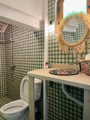 a bathroom with a toilet and a sink and a mirror at Riad Numidia in Marrakech