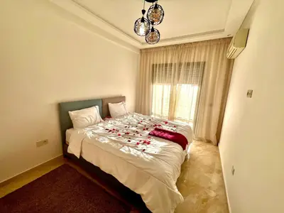a bedroom with a bed with candy canes on it at Appartement à louer in Marrakech