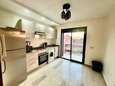 a kitchen with a refrigerator and a dishwasher at Appartement à louer in Marrakech