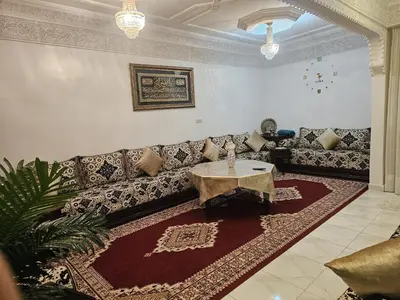 a living room with a couch and a table at Marrakech héberg in Marrakech