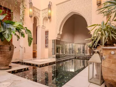 an indoor pool in a building with plants at Riad MAYAN Heated Pool and GYM in Marrakech