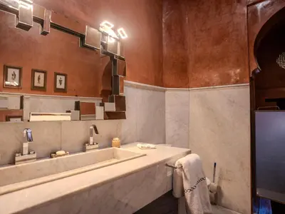 a bathroom with a large sink and a mirror at Riad MAYAN Heated Pool and GYM in Marrakech