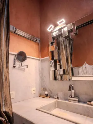 a bathroom with a sink and a mirror at Riad MAYAN Heated Pool and GYM in Marrakech