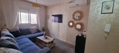 a living room with a blue couch and a table at Cozy appartement à Marrakesh in Marrakech