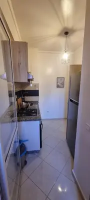 a small kitchen with a stove and a refrigerator at Cozy appartement à Marrakesh in Marrakech
