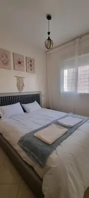 a bedroom with a large bed with towels on it at Cozy appartement à Marrakesh in Marrakech