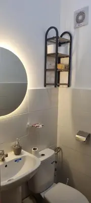 a bathroom with a toilet and a sink and a mirror at Cozy appartement à Marrakesh in Marrakech