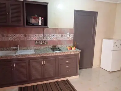 a kitchen with a sink and a white refrigerator at appartement 6 min centre terrasse in Marrakech