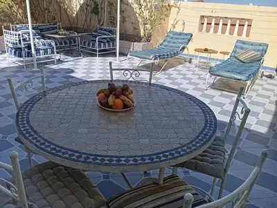 a bowl of fruit on a table on a patio at appartement 6 min centre terrasse in Marrakech