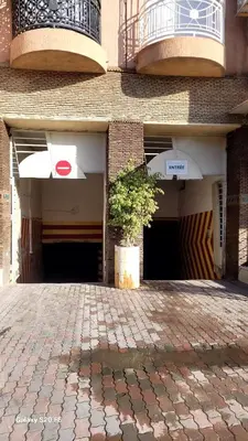 a brick building with a potted plant in front of it at LE 44 face a la gare CTM et a 10mn de L'aéroport in Marrakech