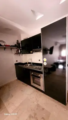 a kitchen with a stove and a sink in it at LE 44 face a la gare CTM et a 10mn de L'aéroport in Marrakech