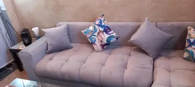 a couch with pillows on it in a living room at Studio Rmila 1 in Marrakech