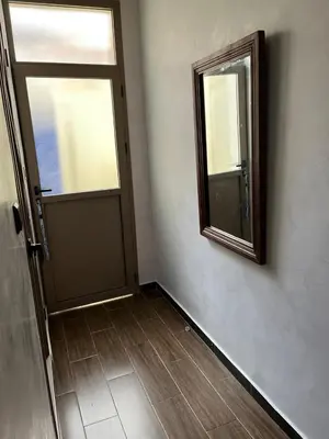 a room with a door and a mirror on the wall at Studio Rmila 1 in Marrakech