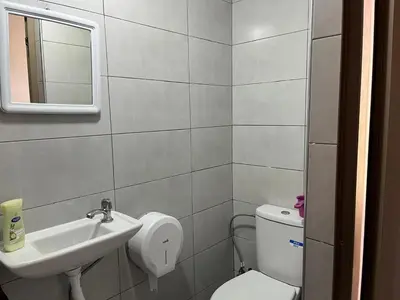 a bathroom with a sink and a toilet and a mirror at Studio Rmila 1 in Marrakech