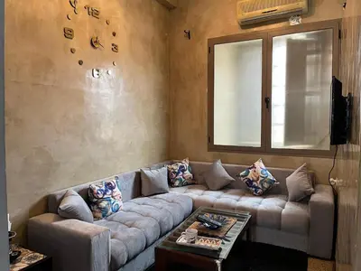 a living room with a couch and a window at Studio Rmila 1 in Marrakech