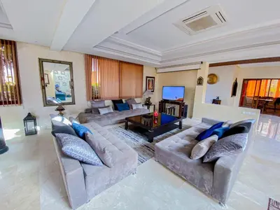 a large living room with couches and a table at Amlkis golf royal in Marrakech
