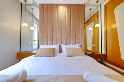 a bedroom with a large white bed with two pillows at Awesome Luxury Apartment in Marrakech in Marrakech