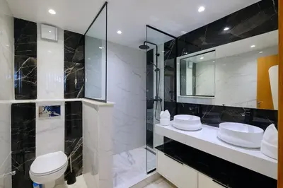 a bathroom with a toilet and a sink and a mirror at Awesome Luxury Apartment in Marrakech in Marrakech