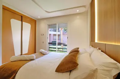 a large white bed in a room with a window at Awesome Luxury Apartment in Marrakech in Marrakech