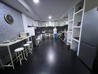 a kitchen with a man standing in the middle at Villa Riad Jawhar & SPA in Marrakech
