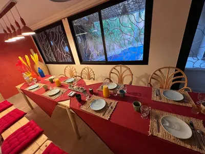 a dining room table with a red table cloth at Villa Riad Jawhar & SPA in Marrakech
