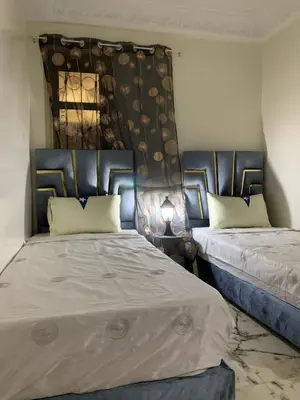 two beds sitting next to each other in a room at Airport Apartment 5 minutes walk, perfect for Early & Late Flights in Marrakech