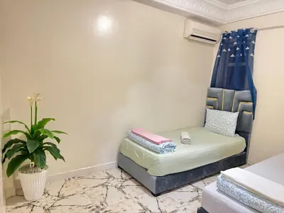 a room with a couch and a potted plant at Airport Apartment 5 minutes walk, perfect for Early & Late Flights in Marrakech