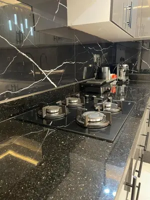 a kitchen counter with a stove top in a kitchen at Modern Apartment Airport in Marrakech