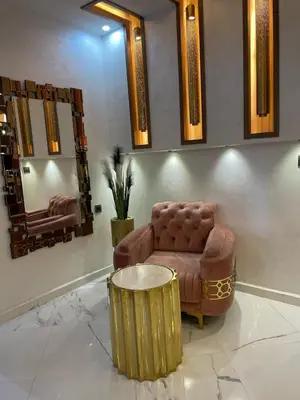 a room with a chair and a table and mirrors at Modern Apartment Airport in Marrakech