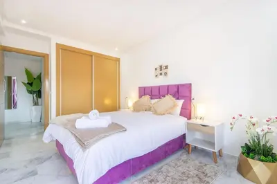 a bedroom with a large bed with a purple headboard at NEW! appt au cœur de Gueliz ,Terrasse,IPTV,parking in Marrakech