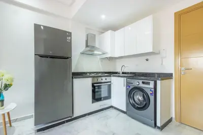 a kitchen with a washing machine and a washer at NEW! appt au cœur de Gueliz ,Terrasse,IPTV,parking in Marrakech