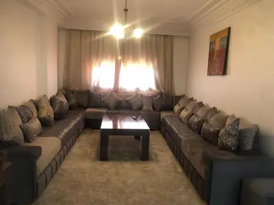 a living room with a couch and a table at - Résidence Babylone Y - 1 Bedroom Appartement in Marrakech
