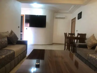 a living room with a couch and a table at - Résidence Babylone Y - 1 Bedroom Appartement in Marrakech