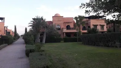 a large house with a lawn in front of it at Havre de paix à Atlas Golf Resort Marrakech in Marrakech