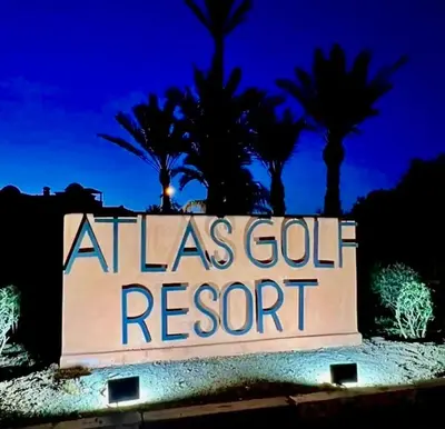 a sign for a las vegas resort with palm trees in the background at Havre de paix à Atlas Golf Resort Marrakech in Marrakech