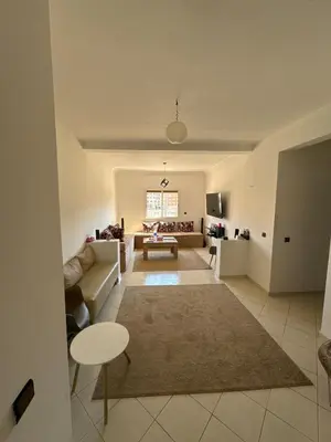 a living room with a couch and a table at Sharing Apartment Standard Room in Marrakech