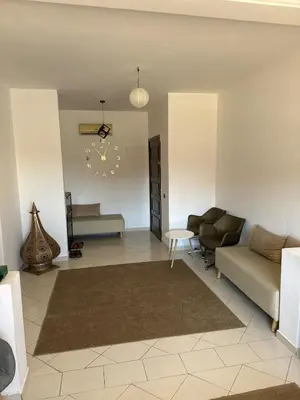 a living room with a couch and a table at Sharing Apartment Standard Room in Marrakech