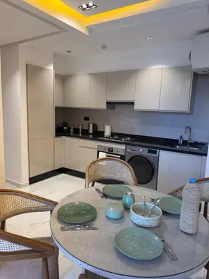 a kitchen with a table with plates on it at Jnane Guéliz 2CH parking wifi Marrakech centre in Marrakech
