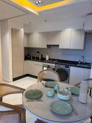 a kitchen with a table with plates on it at Jnane Guéliz 2CH parking wifi Marrakech centre in Marrakech