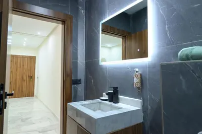 a bathroom with a sink and a mirror at Appartement, Gueliz, WiFi, parking in Marrakech