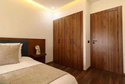 a bedroom with a bed and a wooden door at Appartement, Gueliz, WiFi, parking in Marrakech