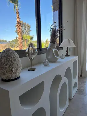 a white table with vases and a lamp and a window at NEW Dar Aït Zahra Marrakech-Cook included-View ATLAS in Marrakech