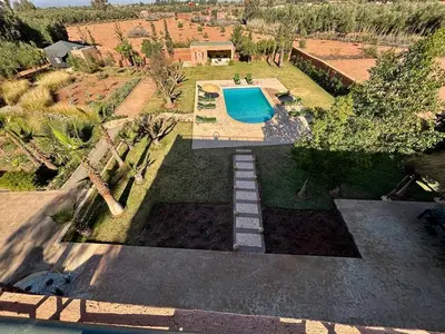 an aerial view of a yard with a swimming pool at NEW Dar Aït Zahra Marrakech-Cook included-View ATLAS in Marrakech